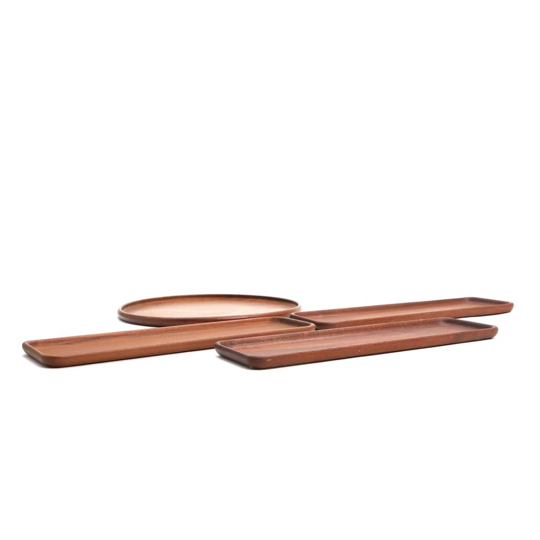 Four teak trays. Stamped Kay Bojesen, Denmark, Copyright. Diam. 40. L. 50 cm. (4) — Modern Decorative Art — Bruun Rasmussen