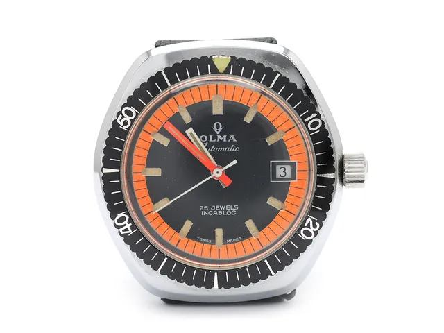 OLMA, herrur, 37,5 mm, Cal ETA 2783, Boett nr. 678, vitmetall, automatisk, plexiglas, datum, skadad urtavla, defekt, gummiband, ca 1970.