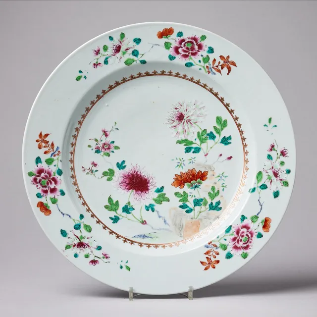 A FAMILLE ROSE DISH, decorated with peonies by rockwork within a fleur-de-lis, Qianlong (1736-1795).