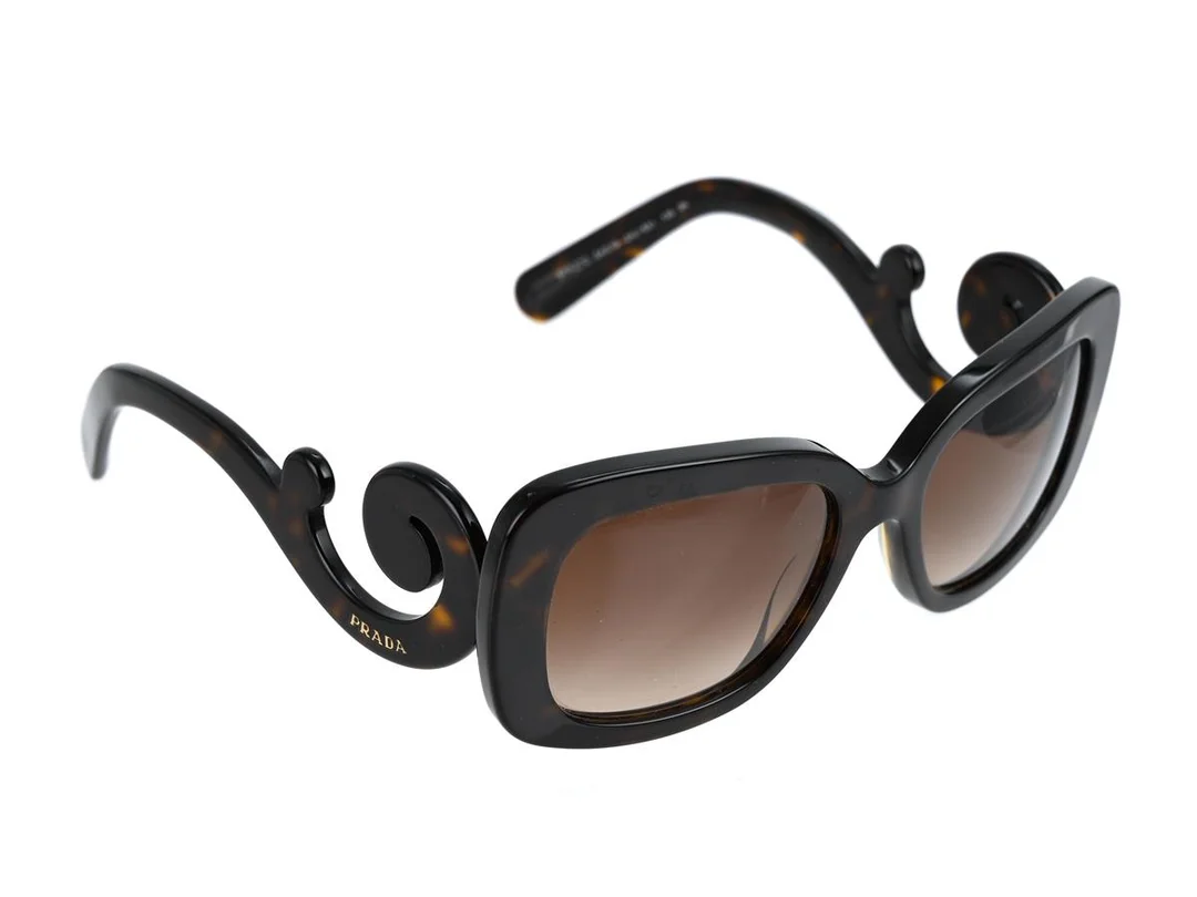 SOLGLASÖGON, PRADA, SPR27O, 54 19, 2AU-6S1, 135, 3N, melerade bågar, bruna glas, putsduk, etui, kartong. — Accessoarer/Solglasögon — Kaplans