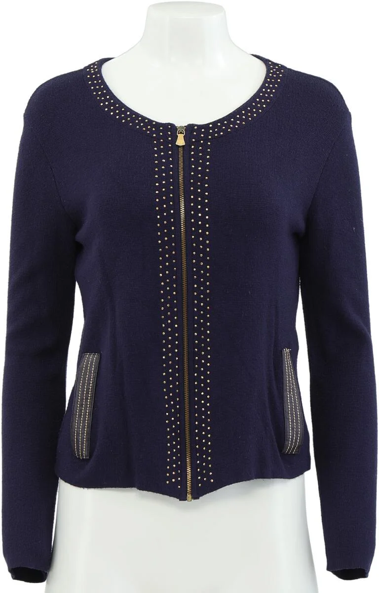 Navy blue cardigan adorned with numerous gold-tone studs, featuring a gold-tone front zipper and two pockets. Length app. 57 cm, chest 42 cm, sleeve length 66 cm. Size S. — Designer Handbags & Fashion — Bruun Rasmussen
