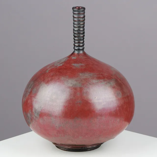 ISAK ISAKSSON (F.1949). Hand-thrown ceramic vase glazed in dark red crystalline glaze with spiral neck, own studio, Sweden, 21st century.