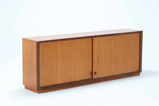 Danish furniture design. Low sideboard made of teak on a low base from the 1960s.