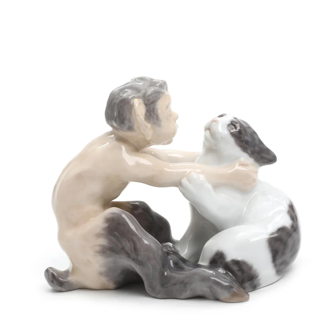 Faun with cat. Porcelain figure, decorated in underglaze colours. 1036. Royal Copenhagen. H. 13 cm. — Porcelain — Bruun Rasmussen
