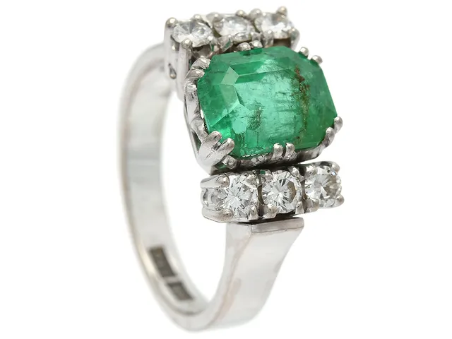 RING, 18K vitguld, smaragdslipad smaragd ca 2,22 ct, 6 briljantslipade diamanter ca 0,40 ctv, ca TW/VS, Bengt J Andersson, Stockholm 1960, stl 16,5 mm, vikt 7,5 g, smaragden med inneslutningar som når ytan, flera diamanter med nagg i rondisten.