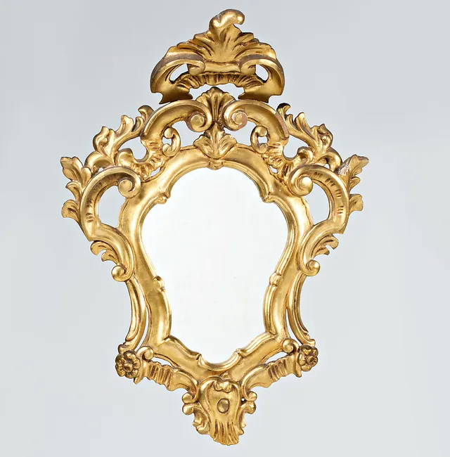 Eighteenth-Century style ornamental mirror in carved and gilt wood, circa 1930-1940.