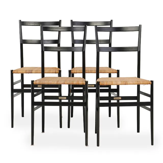 “Superleggera”. Four dining chairs with black lacquered ash frame. Seat stretched with woven cane. Model 699. Designed 1957. Manufactured and partly marked by Cassina, Italy. (4)
