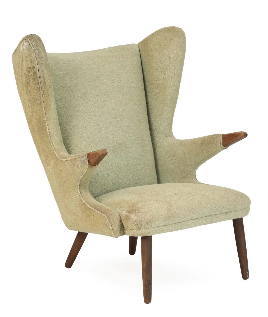 Svend Skipper: Wingback chair with teak legs and “nails”, upholstered with greenish wool. Manufactured by Skipper's Møbler. — Modern Furniture — Bruun Rasmussen