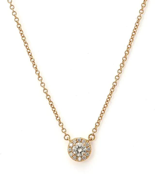 A “Soleste” necklace with a diamond pendant set with a brilliant-cut diamond weighing app. 0.12 ct encircled by numerous brilliant-cut diamonds, mounted in 18k gold. Colour: G. Clarity: VS. Weight app. 1.8 g. Pendant incl. eye-let L. 5.5 mm. L. 40 cm.