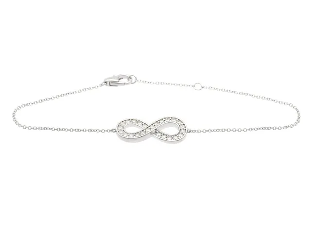 ARMBAND, 18K vitguld, 25 briljantslipade diamanter ca 0,43 ctv, ca W-Cr/VVS-VS, evighetssymbol, längd 16/18 cm, vikt 3,3 g.