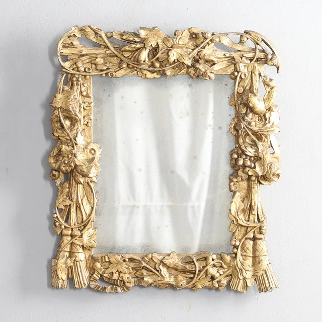 AN ORNATE 19TH CENTURY GILTWOOD WALL MIRROR.