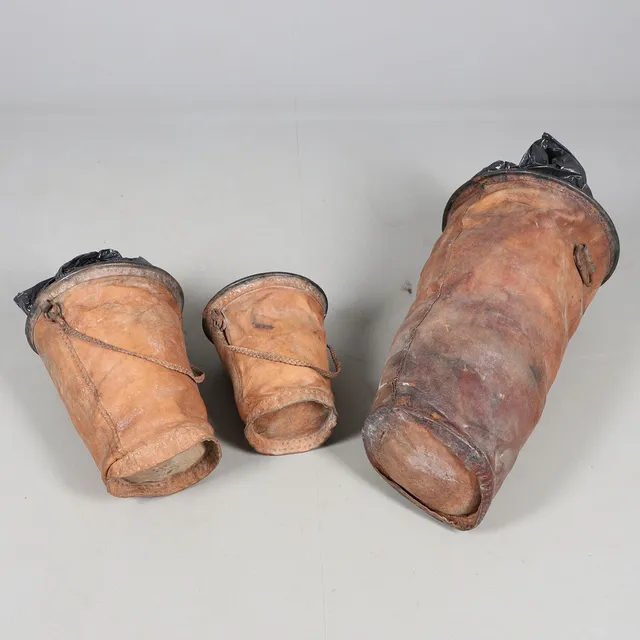 THREE EARLY 20TH CENTURY STITCHED LEATHER BUCKETS.