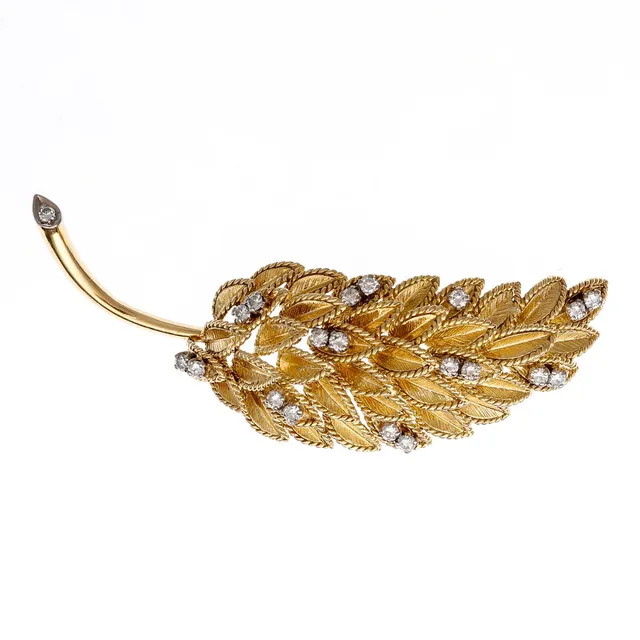 Leaf-shaped gold and diamonds brooch.