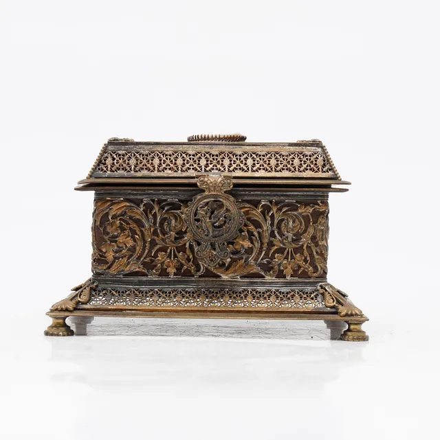 Historicist style chest in openwork metal, 20th Century.