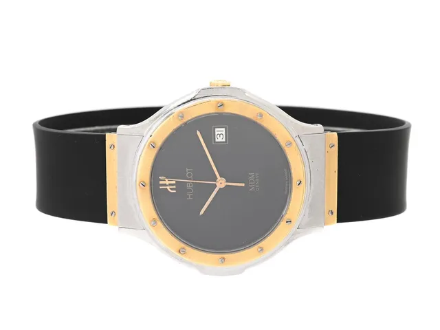 HUBLOT, Genève, MDM, Serie nr. 188637, Boett nr. S 152 10 2, herrur, 36 mm, stål/guld, quartz, safirglas, datum, skadad urtavla, integrerat gummiband, viklås (stål/guld), cert, maj 1987, box (skadad).