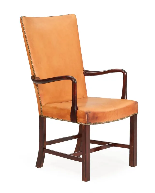 A dark stained beech armchair, upholstered with patinated natural leather fitted with brass nails. Model 1626. Manufactured and marked by Fritz Hansen.