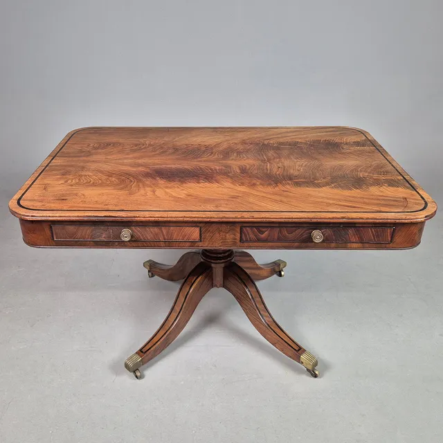 REGENCY MAHOGANY AND EBONISED STRUNG LIBARY TABLE.