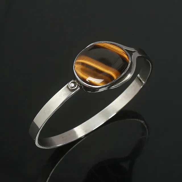 VICTOR JANSSON. Armring, öppningsbar, silver med tigeröga, signerad, Lindesberg 1965.