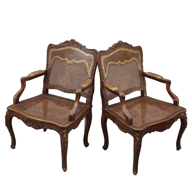 Pair of French Regency armchairs in carved walnut, 18th Century.