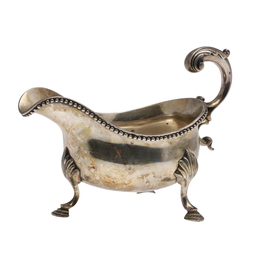 A GEORGE III SILVER SAUCE BOAT. — Silver — Lawrences Auctioneers