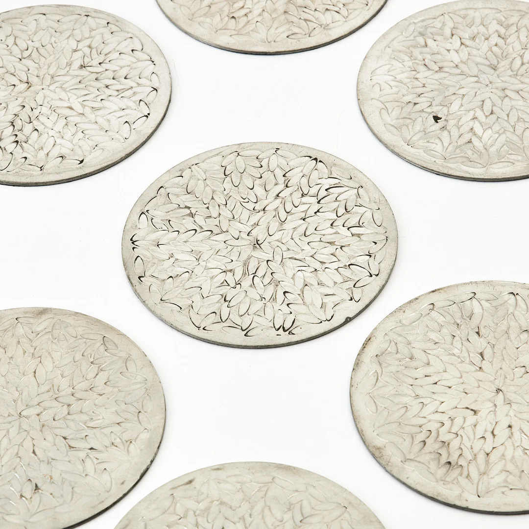 SIGNE PERSSON MELIN. "Myrten", coasters, 10 st., Firma Svenskt Tenn, tenn med reliefdekor. — Pewter, Brass & Copper — Stockholms Auktionsverk Magasin 5