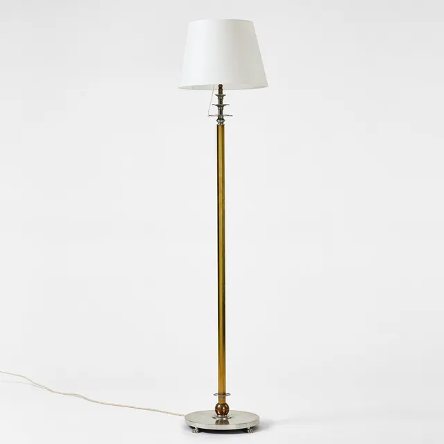 NILS FOUGSTEDT. Floor lamp, Firma Svenskt Tenn, 1930, model 763 A, pewter and brass, faceted brass leg, with geometrical decoration in pewter and brass, base with four lion paws.