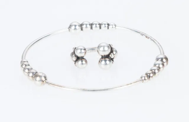 Georg Jensen: A 'Moonlight Grapes' bangle and ring. Size 52. (2)