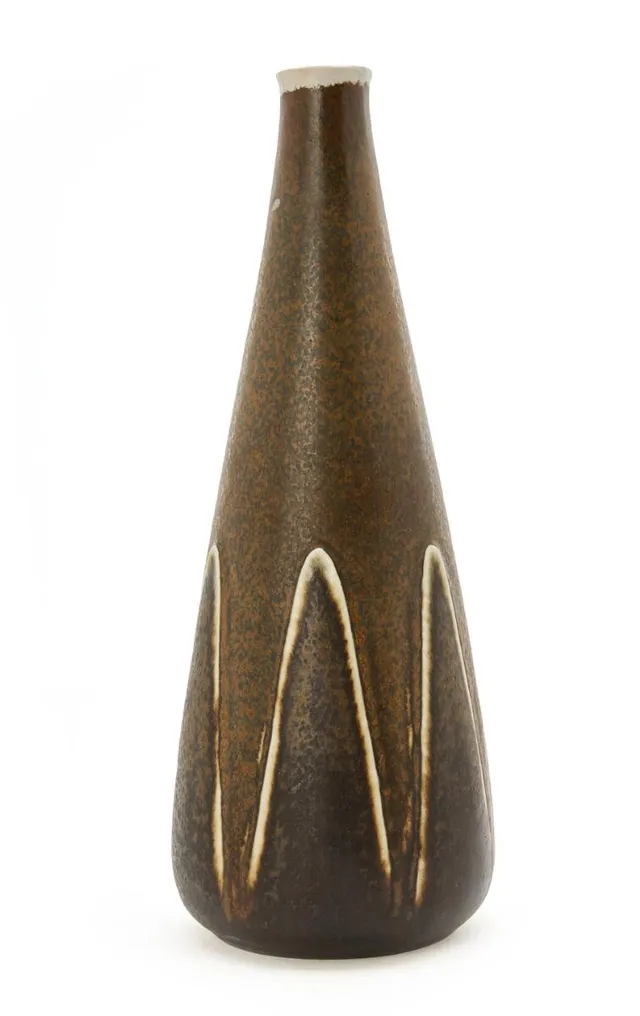 Stoneware vase, lower part modelled with relief decor. Decorated with dark brown glaze with reddish-brown elements. Signed monogram. Made by Royal Copenhagen. H. 31.5 cm.