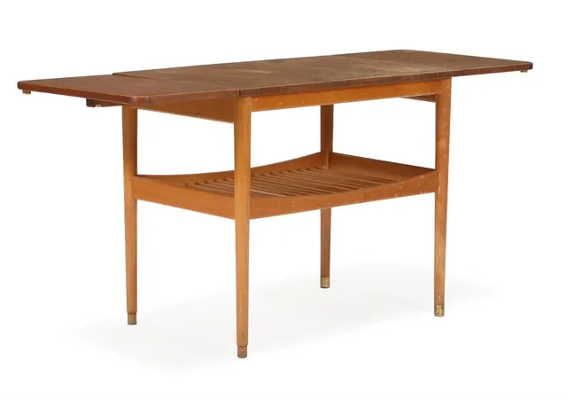 Teak coffee table with walnut top, beech frame with underlying slatted shelf. Brass shoes. Manufactured by Anton Kildeberg, Odense. H. 61. L. 69/94/125. W. 48 cm.