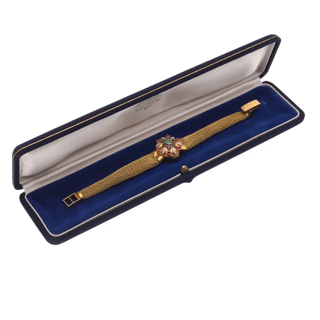 A LADY'S 18CT GOLD AND GEM SET DRESS WRISTWATCH BY OMEGA.