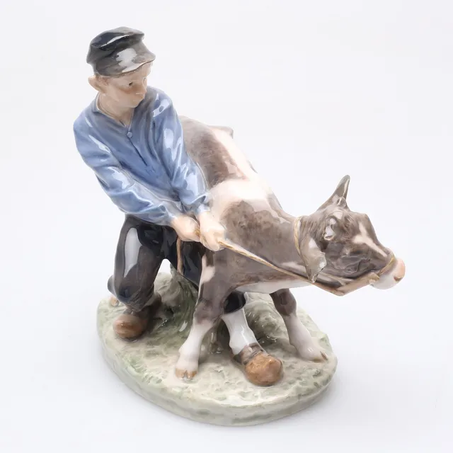 FIGURIN i porslin, pojke med kalv, Royal Copenhagen, Denmark.