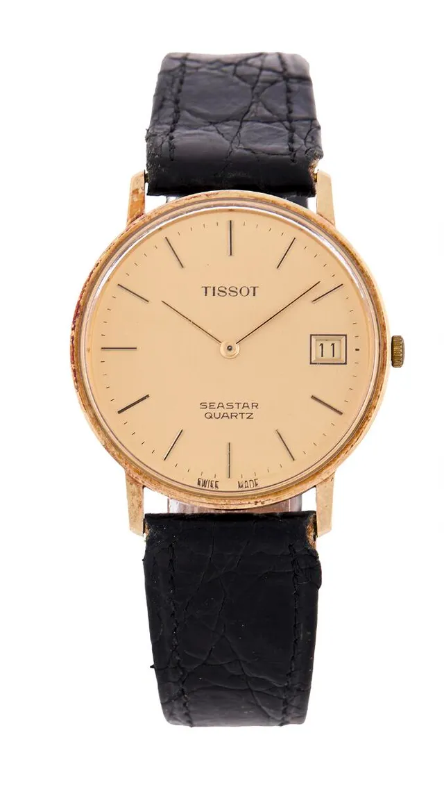 Seastar of 14k gold. Quartz movement with date. Black alligator strap with later gilt C-clasp. Ø 34 mm. 1990s.