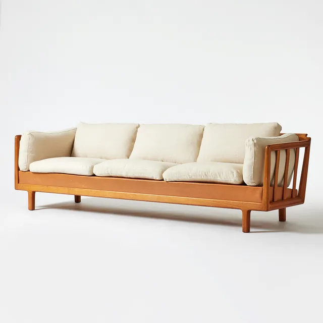 FOLKE OHLSSON. Sofa, DUX, 1960s, walnut frame, leather underseat, cushions with light-colored textile upholstery.