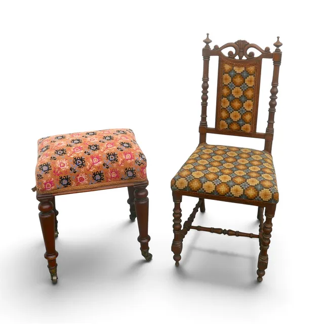 A NEEDLEPOINT UPHOLSTERED CHAIR AND STOOL.