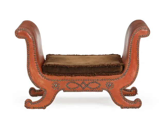 A stool upholstered with cognac coloured leather, fitted with brass nails, loose cushions with brown velour. 1930s.