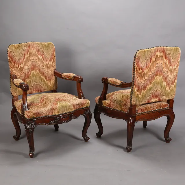 Pair of regency-style armchairs in carved walnut, late 19th-early 20th Century.