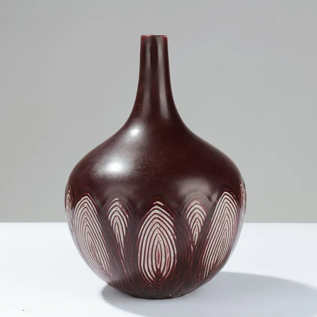 AXEL SALTO. Teardrop-shaped stoneware vase decorated with oxblood glaze and oval reliefs, model no. 20736, designed in 1945, Royal Copenhagen, Denmark.