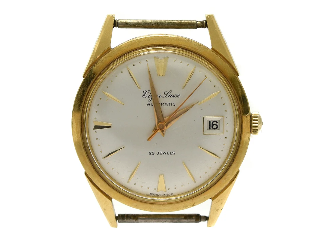 EIGER LUXE, herrur, 34,5 mm, Cal ETA 2452, Boett nr. 8044, 18K guld, automatisk, plexiglas, datum, skadad urtavla, ca 1960. — Klockor/Övriga klockor — Kaplans