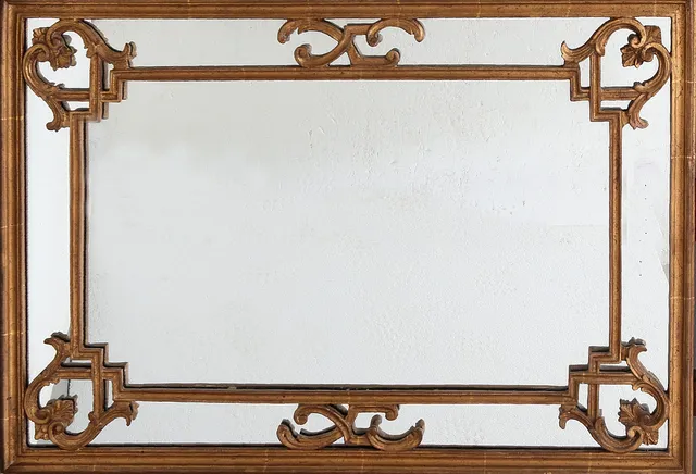 Mirror with frame in carved, gilt and openwork wood, 20th Century.