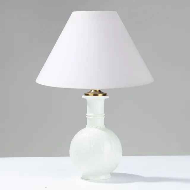 ARNO MALINOWSKI (1899-1976). Bordlampe dekoreret med stiliserede blade i relief, nordisk Art Deco stil, fremstillet af Blanc de Chine porcelæn med messinghætte, modelnr. 3309, Royal Copenhagen, Danmark, udført i 1936.