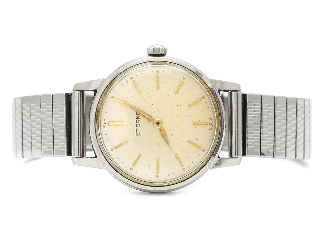 ETERNA, herrur, 33 mm, Serie nr. 4128949, Boett nr. 4243798, stål, manuell, plexiglas, skadad urtavla, ca 1960, metallänk ej original. — Klockor/Eterna — Kaplans