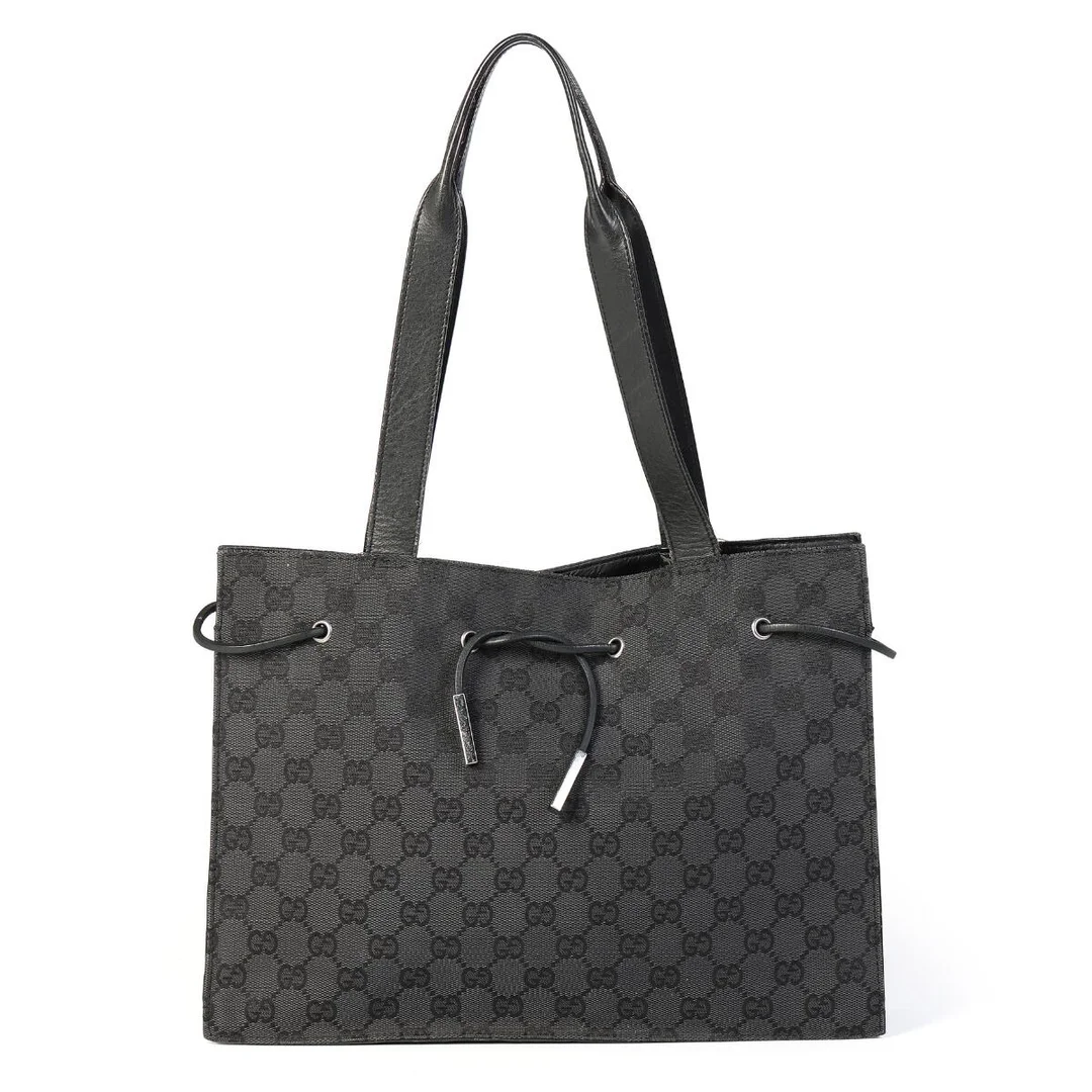 A bag of black monogram canvas with black leather trimmings, silver tone hardware, two handles, one compartment with a zipped pocket and black lining. H. 24 x W. 33 x D. 8 cm. — Designer Handbags & Fashion/Designer Handbags — Bruun Rasmussen