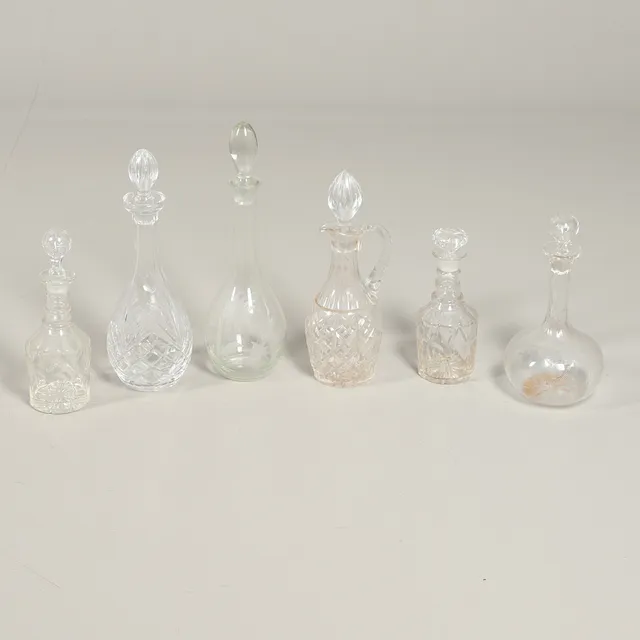 SIX CUT GLASS DECANTERS.