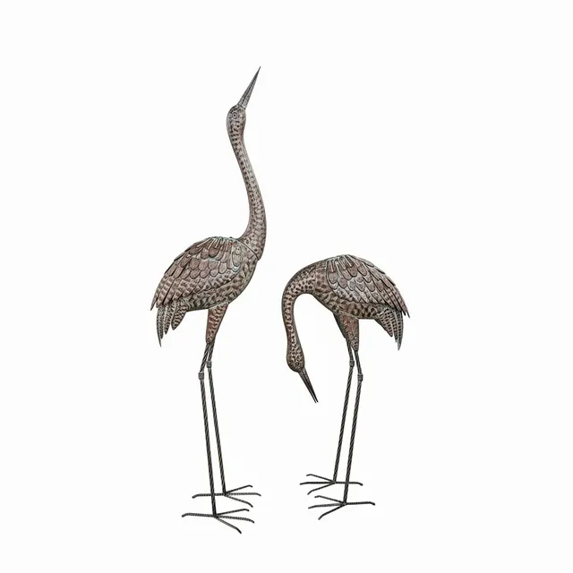 Pareja de grullas en metal patinado.