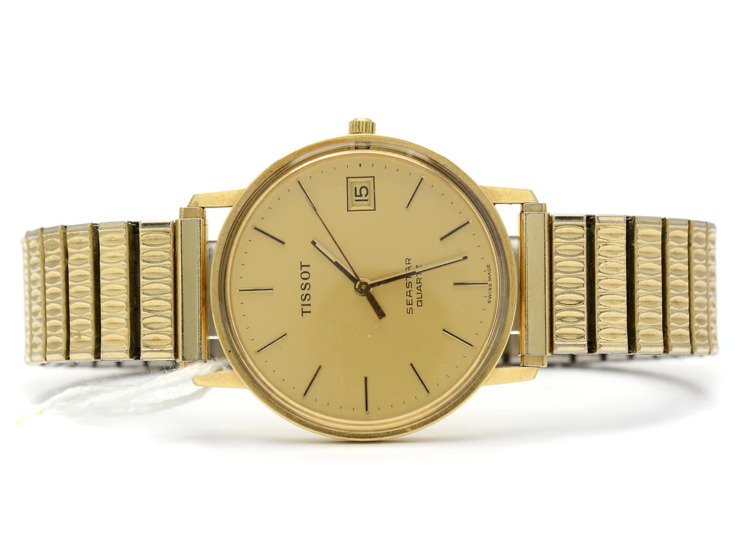 Tissot Seastar, 14K i boett, Ø33mm, quartz, datum, plastglas, flexlänk i stål, sliten bakboett, batteribyte krävs — Klockor/Tissot — Kaplans