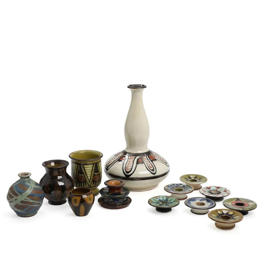 Collection of earthenware comprising five vases and eight candlesticks decorated with glaze in cream, green, blue a.o. colours. Signed HAK. Manufactured by Kähler. H. 2.5–30. Candlesticks diam. 8–9 cm. (13) — Modern Decorative Art — Bruun Rasmussen