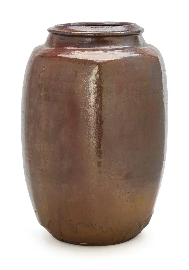 A high-fire earthenware floor vase. Modelled in edged shape and with round mouth. Decorated with reddish brown glaze with ochre elements. Signed Gutte. Unique. H. 41.5 cm.