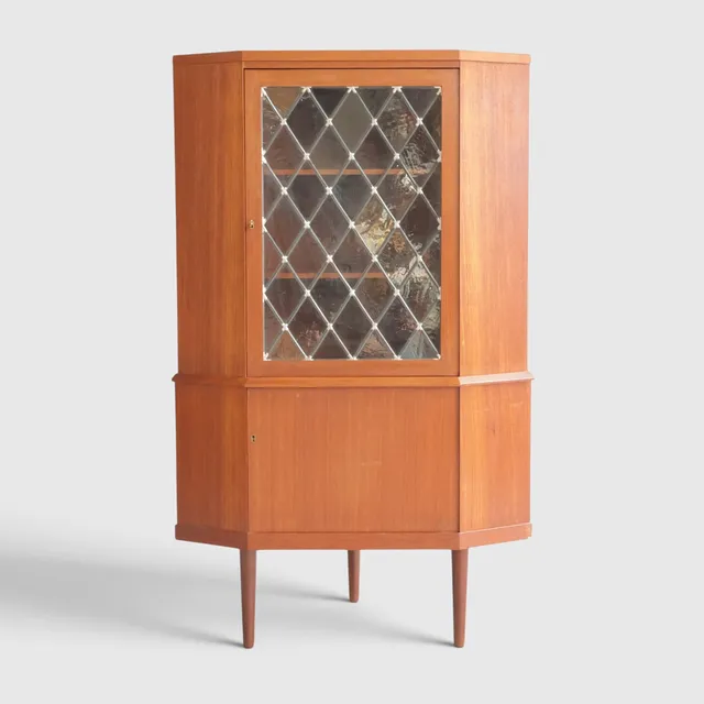 Hjørneskab af teak, front med to låger heraf ene med blyindfattede ruder bag hvilke hylder. Danmark, 1960'erne.