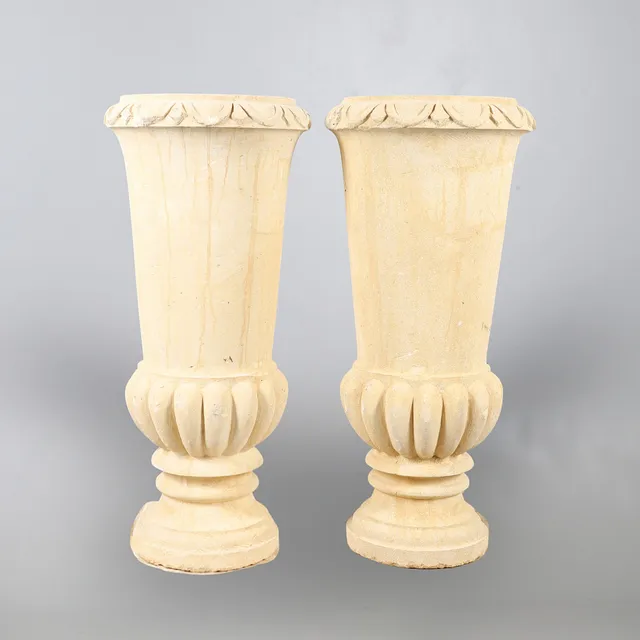 A PAIR OF CONTEMPORARY EGYPTIAN CARVED STONE URNS.