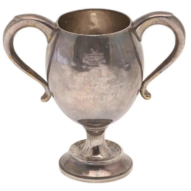 A GEORGE V SILVER TWIN HANDLED TROPHY CUP, MILITARY INTEREST.